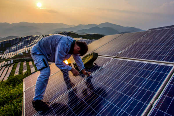 A worker installing solar panels in Songxi, China, in 2016. (Feature China/Barcroft Images/Barcroft Media via Getty Images)