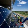 Installers attach photovoltaics to the south face of the NREL parking garage