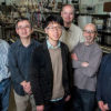 Six scientists involved with the newly published research into perovskites stand inside a laboratory.