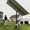 A customer inspects a solar panel that is linked to a Tesla Inc. Powerwall at a home in Monkton, Vt.,
