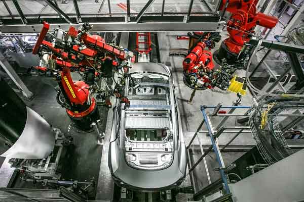 Robotic-arms-work-on-the-body-of-a-Tesla-Model-3-at-the-company's-factory-in-Fremont