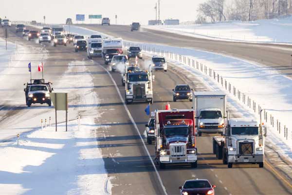 United-We-Roll-convoy-of-semi-trucks-travels-the-highway-near-Red-Deer