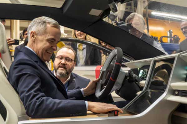 Automotive-Parts-Manufacturers’-Association-President-Flavio-Volpe-shows-Prime-Minister-Mark-Carney,-front,-the-Project-Arrow-2.0-prototype-vehicle