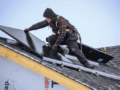 solar installer on a roof in winter